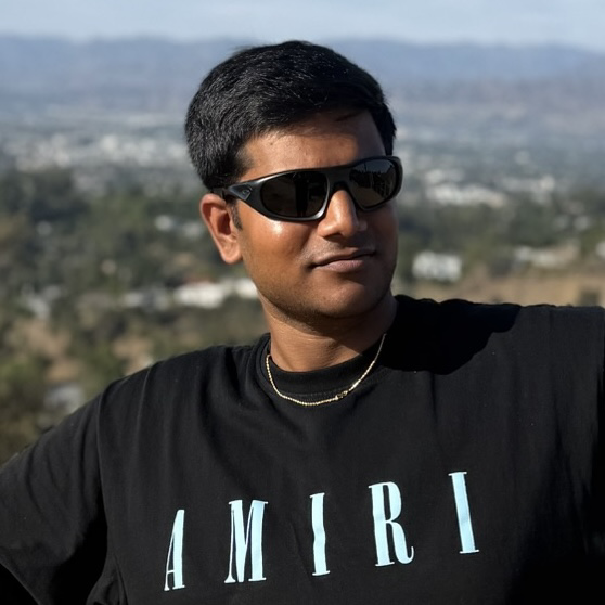 Tejas wearing sunglasses at a scenic overlook